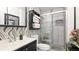 Modern bathroom features a glass-enclosed shower, a black vanity, and stylish black and white patterned wallpaper at 13492 Dibella Ave, Port Charlotte, FL 33981