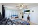 Cozy bedroom featuring a decorative accent curtain, ceiling fan, and a calming atmosphere at 13492 Dibella Ave, Port Charlotte, FL 33981