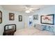 Inviting bedroom with ceiling fan, multiple art pieces, and comfortable bedding at 13492 Dibella Ave, Port Charlotte, FL 33981