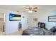 Bright bedroom with tropical wall art, neutral walls, a ceiling fan, and modern decor at 13492 Dibella Ave, Port Charlotte, FL 33981