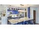 Modern kitchen with blue cabinets, stainless steel appliances, white countertops, and barstool seating at 13492 Dibella Ave, Port Charlotte, FL 33981