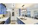 Updated kitchen featuring blue cabinets, a white countertop island, and stainless steel appliances at 13492 Dibella Ave, Port Charlotte, FL 33981