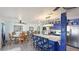 Open concept kitchen and dining area with blue cabinets, white countertops, and modern appliances at 13492 Dibella Ave, Port Charlotte, FL 33981
