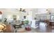 Spacious living room with lots of seating, chandeliers, and natural light, creating a cozy atmosphere at 13492 Dibella Ave, Port Charlotte, FL 33981