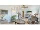 Bright, open-concept living room featuring stylish seating, elegant decor, and lots of natural light at 13492 Dibella Ave, Port Charlotte, FL 33981