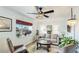Bright living room showcasing a comfortable sofa, stylish decor, a large window, and a ceiling fan at 13492 Dibella Ave, Port Charlotte, FL 33981