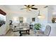 Bright living room showcasing a comfortable sofa, stylish decor, a large window, and a ceiling fan at 13492 Dibella Ave, Port Charlotte, FL 33981