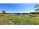 This expansive backyard features a serene pond view and lush green grass at 15332 Serene Shores Loop St, Bradenton, FL 34211