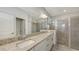 Elegant bathroom features a double vanity with granite countertops and a glass-enclosed shower at 15332 Serene Shores Loop St, Bradenton, FL 34211