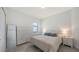 Serene bedroom with a queen-sized bed, a window, and a modern dresser and nightstand set for ample storage at 15332 Serene Shores Loop St, Bradenton, FL 34211