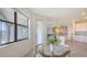 Sunny breakfast nook boasts a glass table, opening to the living room and kitchen area at 15332 Serene Shores Loop St, Bradenton, FL 34211