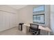 Bright home office featuring a modern desk, ergonomic chair, and ample natural light from a window with blinds at 15332 Serene Shores Loop St, Bradenton, FL 34211