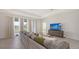 Living room with a comfortable sofa, large windows, and modern entertainment center at 15332 Serene Shores Loop St, Bradenton, FL 34211