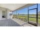 Screened patio with brick flooring offers beautiful backyard views of green space and a pond at 15332 Serene Shores Loop St, Bradenton, FL 34211