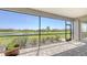 The screened in patio with brick flooring has great views of the lush green space and waterway at 15332 Serene Shores Loop St, Bradenton, FL 34211