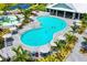 Aerial view of community pool and lounge area with many chairs and umbrellas at 15332 Serene Shores Loop St, Bradenton, FL 34211
