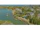 Areal view of a waterfront property with a private dock, pool, lush landscaping, and beautiful surroundings at 1540 Hillview Dr, Sarasota, FL 34239
