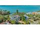 Waterfront home showcasing its beautiful location with direct water access, tropical landscaping and neighborhood at 1540 Hillview Dr, Sarasota, FL 34239