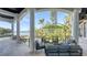 Beautiful covered porch features outdoor seating area with a waterfront view and access to the pool at 1540 Hillview Dr, Sarasota, FL 34239