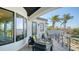 Inviting outdoor balcony featuring chic seating and panoramic water views, perfect for enjoying tranquil moments at 1540 Hillview Dr, Sarasota, FL 34239
