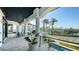 Expansive covered balcony offering beautiful views of the lush landscape and sparkling pool below at 1540 Hillview Dr, Sarasota, FL 34239