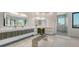 Modern bathroom with dual sinks, makeup vanity, and large windows that enhance the bright and airy feel at 1540 Hillview Dr, Sarasota, FL 34239