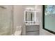 Bathroom featuring a glass enclosed shower, sleek vanity, and a modern, illuminated mirror at 1540 Hillview Dr, Sarasota, FL 34239