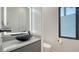 Sleek bathroom with a stylish black vessel sink, modern vanity, and window offering natural light at 1540 Hillview Dr, Sarasota, FL 34239