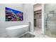 Elegant bathroom with a freestanding tub, marble flooring, and a walk-in shower, showcasing luxurious design elements at 1540 Hillview Dr, Sarasota, FL 34239