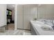 Modern bathroom featuring marble floors, walk-in closet, sleek vanity, and lots of storage space at 1540 Hillview Dr, Sarasota, FL 34239