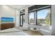 Serene bedroom features floor to ceiling windows, access to a balcony, and stylish seating, providing a relaxing retreat at 1540 Hillview Dr, Sarasota, FL 34239