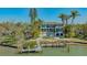 Beautiful waterfront home with dock, lush landscaping, and a sparkling pool for luxurious outdoor living at 1540 Hillview Dr, Sarasota, FL 34239