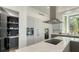 Modern kitchen featuring stainless steel appliances, a large island with a marble countertop, and custom cabinets at 1540 Hillview Dr, Sarasota, FL 34239