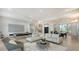 Spacious living area with stylish sofas, a pool table, staircase, and modern design at 1540 Hillview Dr, Sarasota, FL 34239