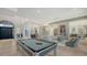 Open-concept living area with a pool table, modern decor, and seamless flow to dining and kitchen at 1540 Hillview Dr, Sarasota, FL 34239
