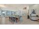 Open concept dining and living space with a modern chandelier, stylish furniture, and large windows with views at 1540 Hillview Dr, Sarasota, FL 34239