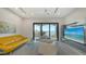 Spacious living room with comfortable seating, wall-mounted TV, and balcony access, offering a relaxing retreat at 1540 Hillview Dr, Sarasota, FL 34239