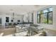 Expansive living room featuring sleek furniture, hardwood floors, and large windows with views of tropical greenery at 1540 Hillview Dr, Sarasota, FL 34239