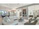 Bright living room showcasing modern sofas, a fireplace, and an open layout to the kitchen and dining areas at 1540 Hillview Dr, Sarasota, FL 34239