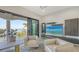 Contemporary living area with water view from a large sliding door, offering an amazing sight at 1540 Hillview Dr, Sarasota, FL 34239