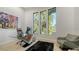 Bright office with large windows, contemporary artwork, and a modern glass desk with comfortable seating at 1540 Hillview Dr, Sarasota, FL 34239