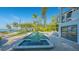 Luxurious pool and spa with modern design, reflecting the surrounding lush landscaping and waterfront views at 1540 Hillview Dr, Sarasota, FL 34239