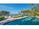 Inviting pool area with sleek lounge chairs, waterfront views, and lush landscaping creating a private oasis at 1540 Hillview Dr, Sarasota, FL 34239