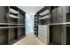 Spacious walk-in closet with custom shelving, drawers, and ample space for organization at 1540 Hillview Dr, Sarasota, FL 34239