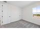 A bright bedroom features neutral walls and plush carpeting, complemented by natural light from a window at 164 Eagleston Ln, Sarasota, FL 34240