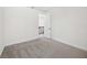 This bright bedroom boasts gray carpet and an open door to the hallway at 164 Eagleston Ln, Sarasota, FL 34240