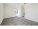 This bright bedroom boasts gray carpet and a window and view to the hallway at 164 Eagleston Ln, Sarasota, FL 34240