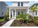Inviting front porch of a two-story home, featuring manicured landscaping and modern architectural details at 164 Eagleston Ln, Sarasota, FL 34240