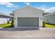 A well-maintained two car garage with a gray door in a residential neighborhood on a sunny day at 164 Eagleston Ln, Sarasota, FL 34240
