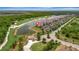 Scenic aerial view overlooking a golf course, lake, and condos with covered parking at 17118 Vardon Ter # 101, Bradenton, FL 34211